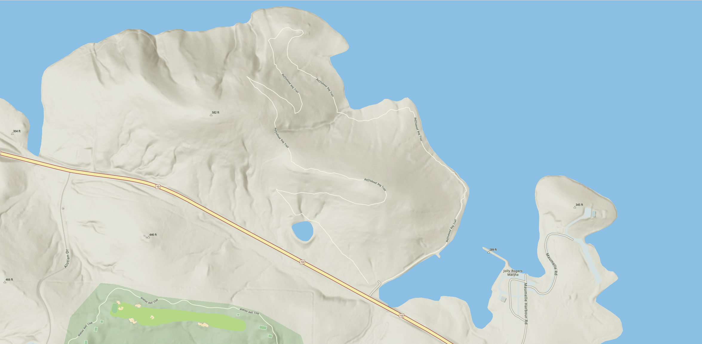 A topographic map showing a coastal area with hills, water bodies, and a highway, labeled with elevation markers and road names.
